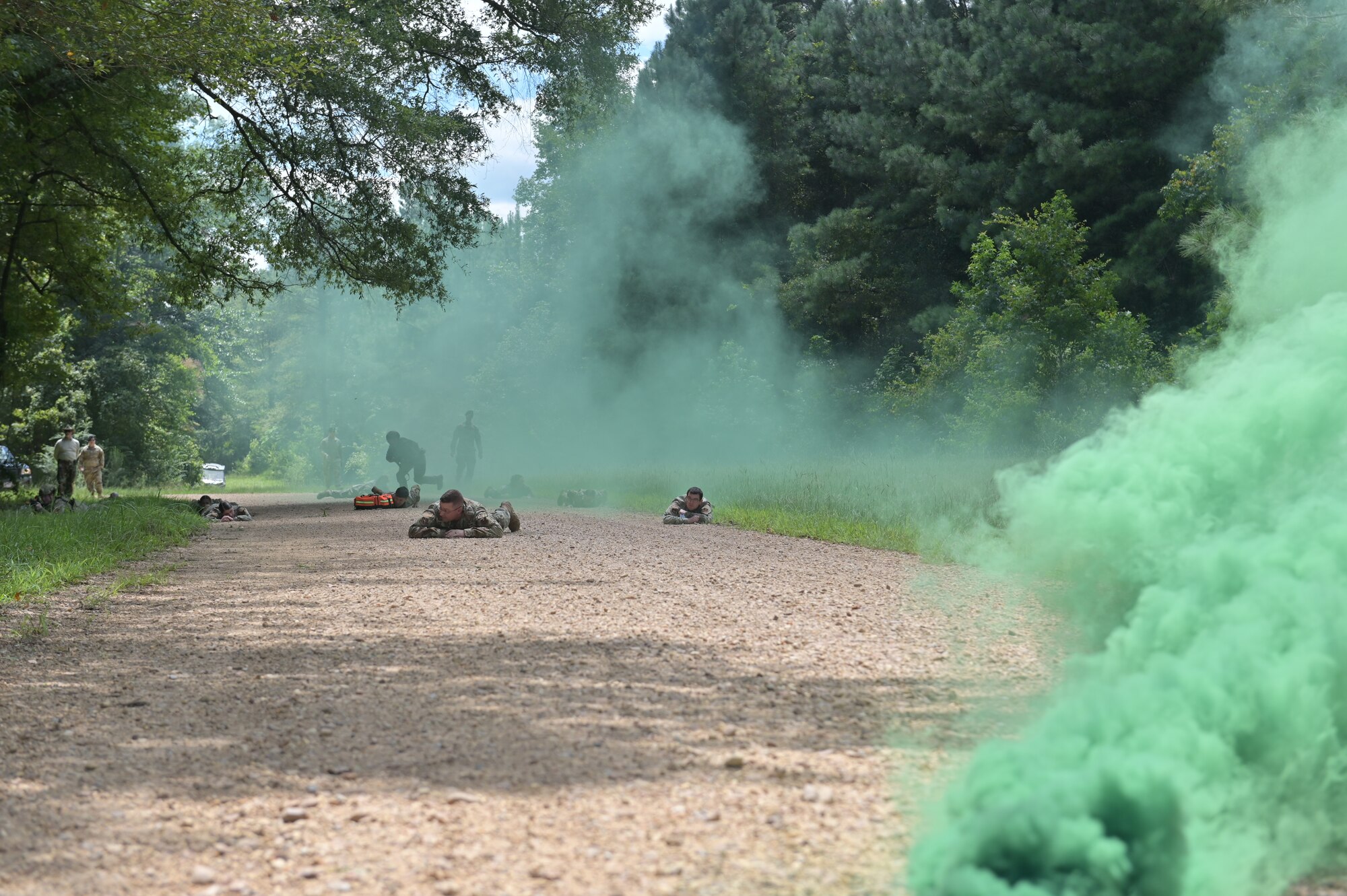 Medical personnel take cover as they are attacked by simulated combatants.