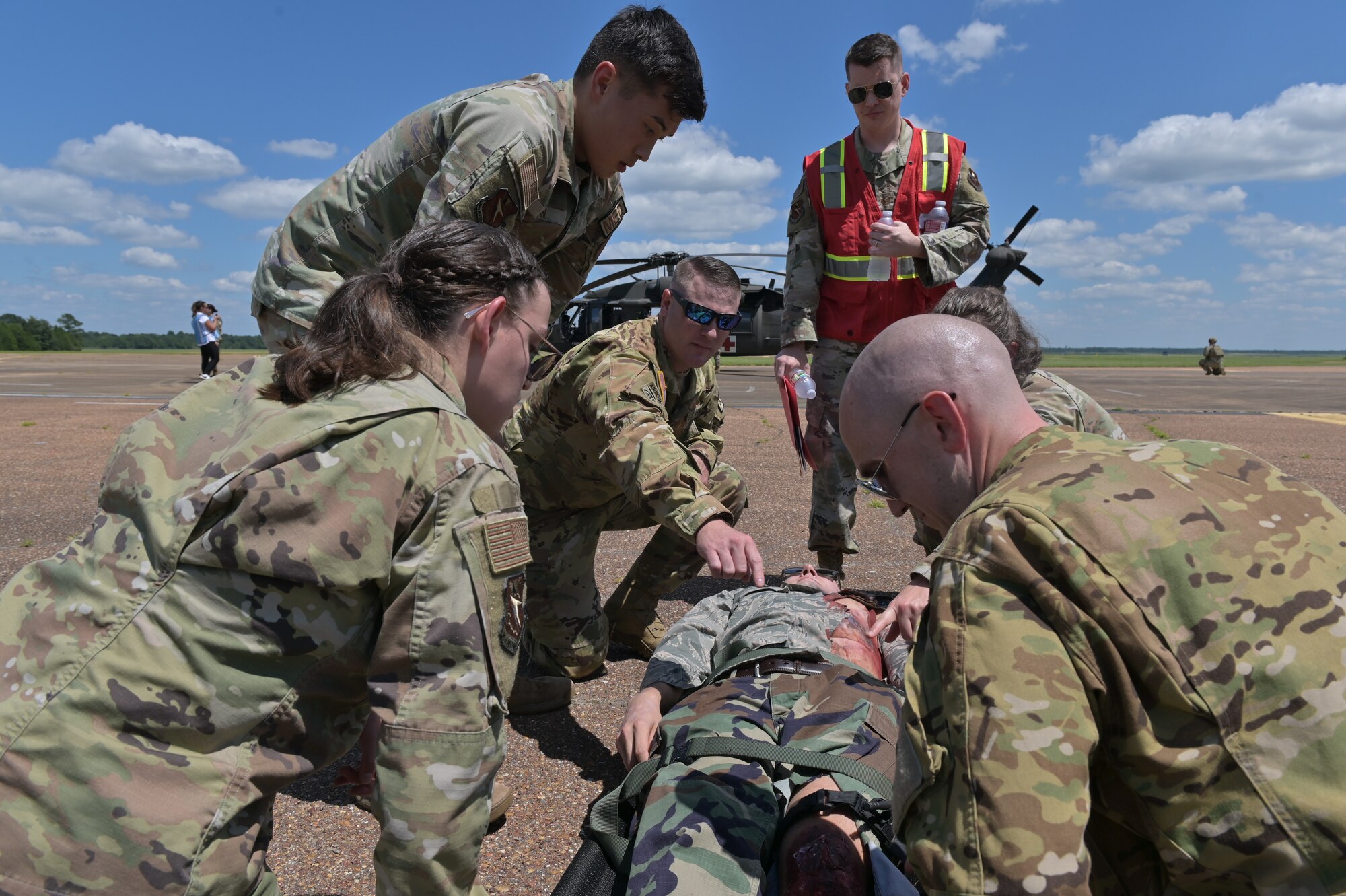 Medical personnel assess a simulated patient.