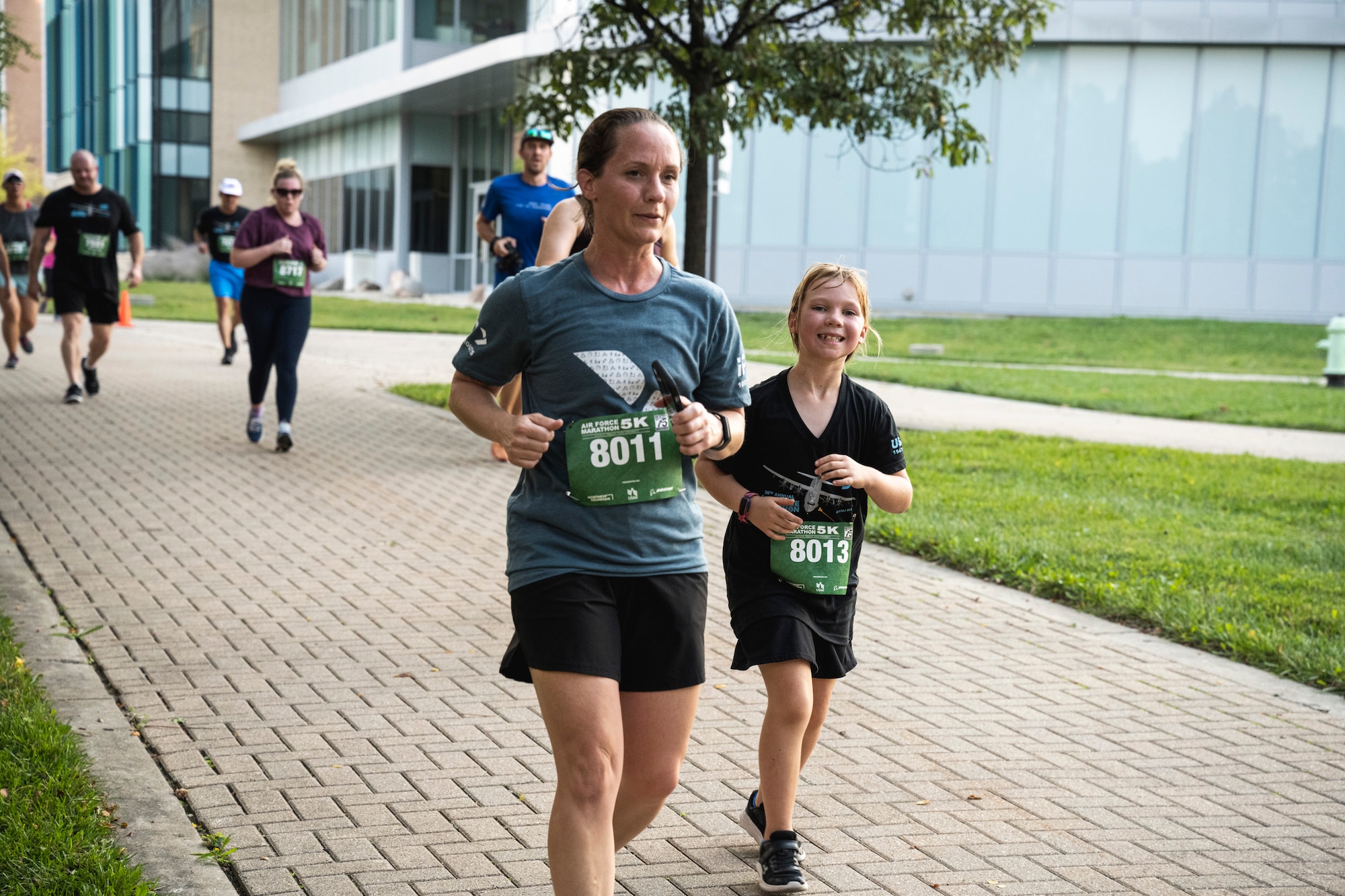 Runners with race bibs on the 5k course.