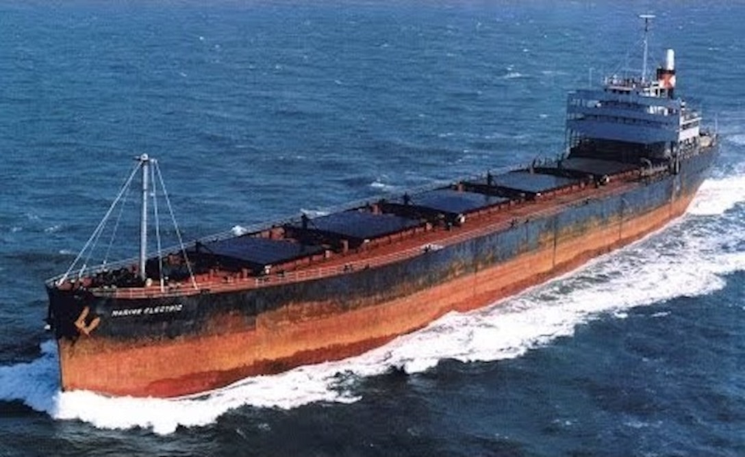 Aerial color photograph of the Marine Electric underway in better times. Built during World War II, the frail cargo vessel was 40 years old when it broke apart on Feb. 12, 1983. (U.S. Coast Guard photo)