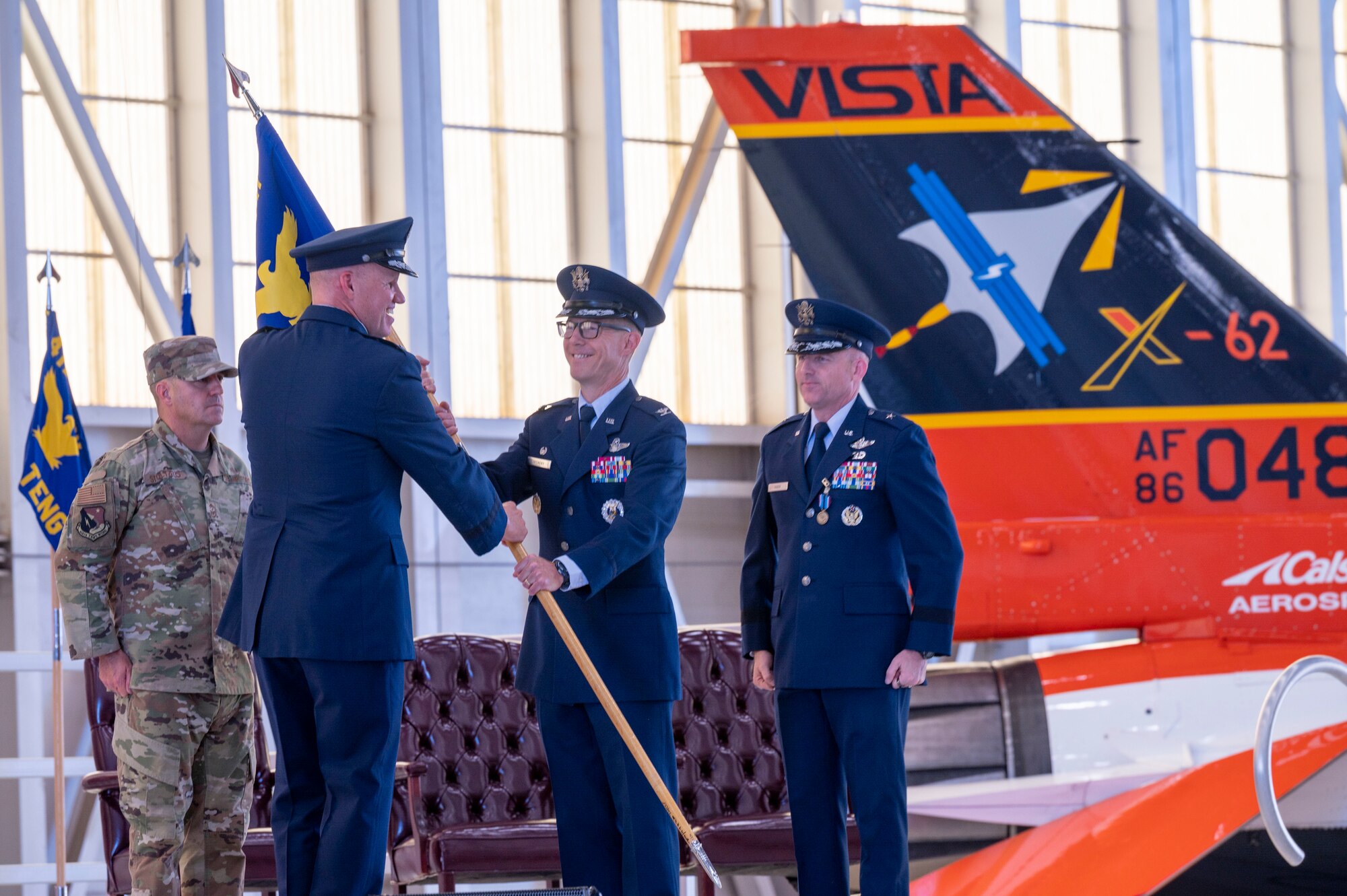 The 412th Test Wing’s new commander, Col. Douglas Wickert, assumes command of the Wing by receiving the unit guidon from Maj. Gen. Evan Dertien, Air Force Test Center commander, during the Wing’s Change of Command Ceremony at Edwards Air Force Base, California, Aug.18.