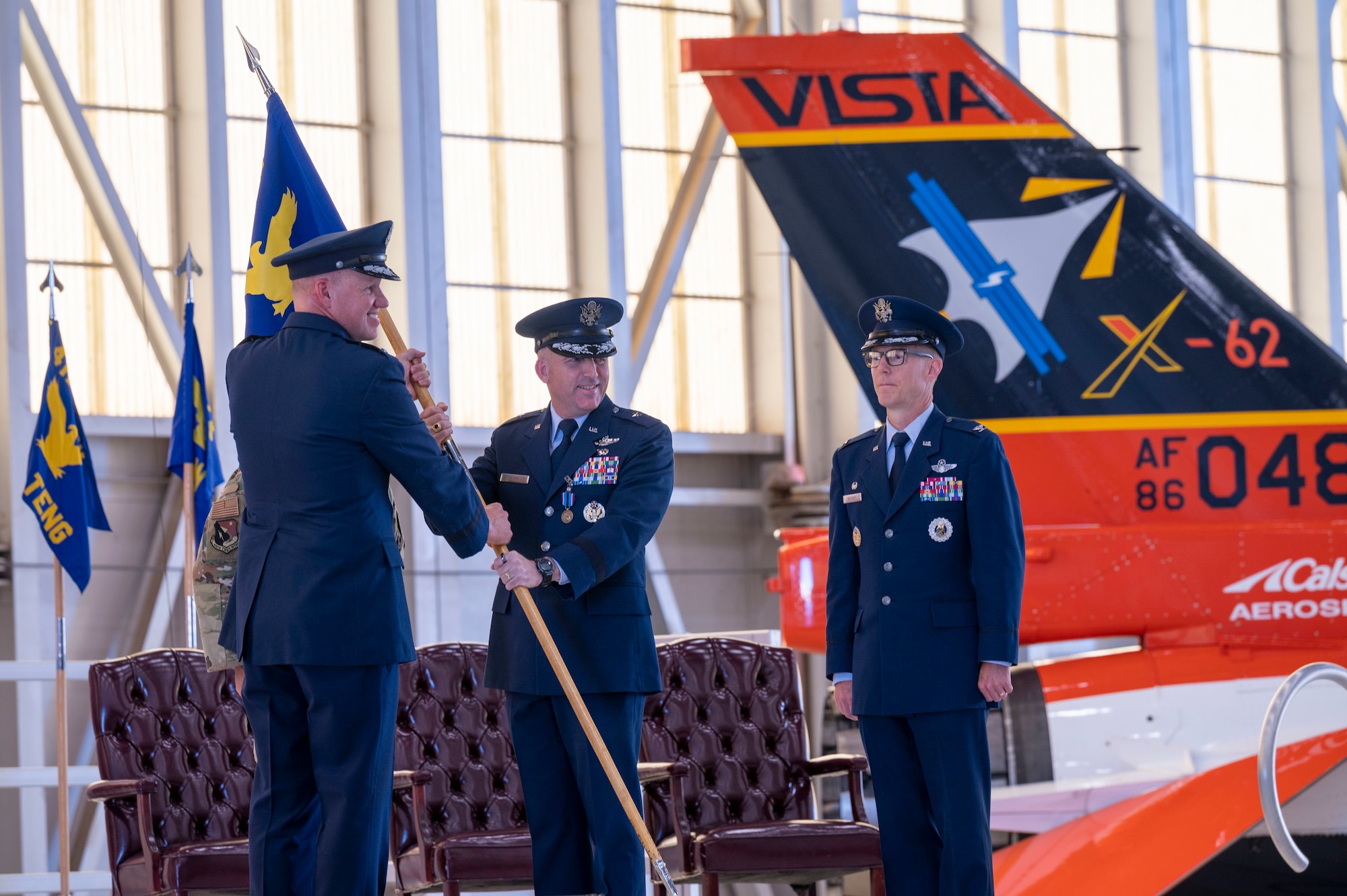 Brig. Gen. Matthew Higer, the outgoing 412th Test Wing Commander, relinquishes his command of the Wing by returning the unit’s guidon to Maj. Gen. Evan Dertien, Air Force Test Center commander, during the Wing’s Change of Command Ceremony at Edwards Air Force Base, California, Aug.18.