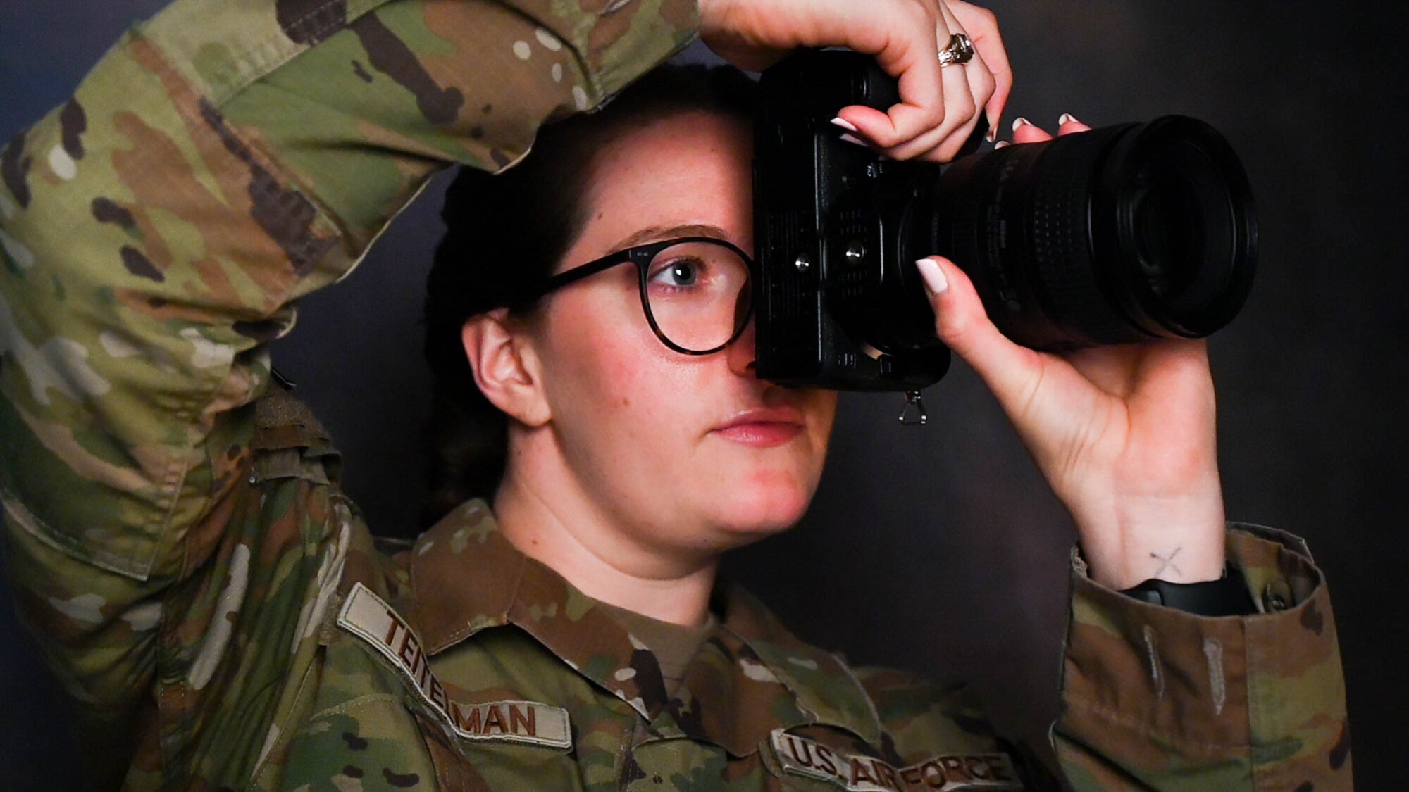 U.S. Air Force 1st Lt. Elisabeth Teitelman, 97th Air Mobility Wing chief of public affairs, takes a photo at Altus Air Force Base, Oklahoma, Aug. 8, 2023. “It is critical that women keep stepping up and speaking out to empower other women to do the same. A diverse force is a strong force — I am beyond proud to be part of the 20% of women who serve in the Air Force and hope that my service will inspire other women to serve as well.” (U.S. Air Force photo by Airman 1st Class Miyah Gray)
