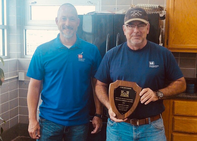 Tim Fudge (Left), U.S. Army Corps of Engineers Nashville District Operations Division chief, presents the Operations and Maintenance Castle Award, on behalf of the Great Lakes and Ohio River Division, to Greg Cox, Fort Loudoun Lock and Melton Hill Lock work leader, during a site visit July 27, 2023, to Fort Loudoun Lock on the Tennessee River in Lenoir City, Tennessee. (USACE Photo by Matt Emmons)