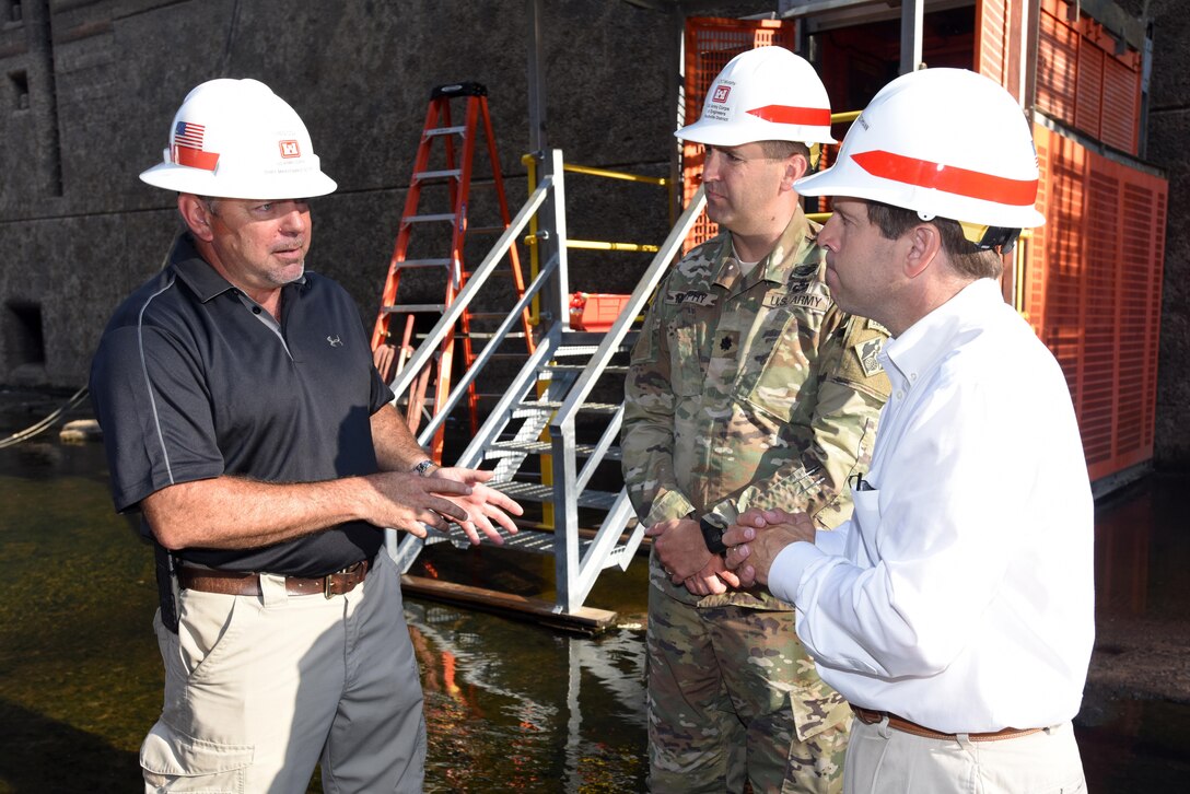 Greg Cox (Left) provides an update about the ongoing inspection and repairs at the dewatered Chickamauga Lock to Congressman Chuck Fleischmann, Tennessee District 3, and Lt. Col. Stephen Murphy, U.S. Army Corps of Engineers Nashville District commander, inside the chamber Aug. 3, 2016. At the time, Cox served as the Nashville District Repair Party and Fleet Maintenance chief. (USACE Photo by Lee Roberts)