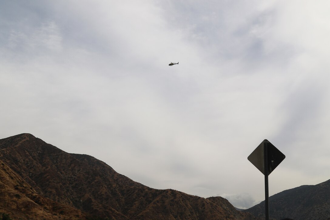 A helicopter owned and operated by the Los Angeles County Sheriff’s Department circles the riverbeds near Santa Fe Dam Aug. 19 to urge homeless individuals living in the riverbeds to seek shelter prior to the impending tropical storm Hurricane Hilary in Azusa, California. Multiple law enforcement agencies, including the LA County Sheriff’s Department’s Homeless Outreach Service’s Team, Azusa and Irwindale police departments; the U.S. Army Corps of Engineers Los Angeles District’s Operations Division; and the Los Angeles Homeless Services Authority collaborated on efforts to evacuate homeless individuals near the dam to safety prior to the impending tropical storm Hurricane Hilary.