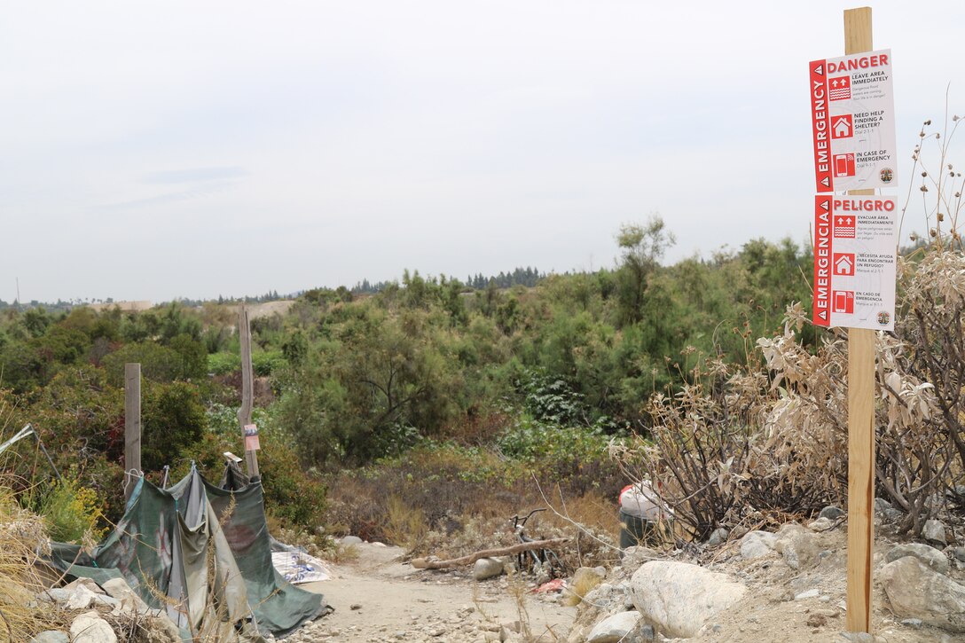 A sign posted near a homeless encampment warning of the dangers coming from the impending tropical storm Hurricane Hilary is a stern reminder for those living in the riverbeds near the Santa Fe Dam to seek shelter away from potential flood waters in the area Aug. 19 in Azusa, California. Multiple law enforcement agencies, including the LA County Sheriff’s Department’s Homeless Outreach Service’s Team, Azusa and Irwindale police departments; the U.S. Army Corps of Engineers Los Angeles District’s Operations Division; and the Los Angeles Homeless Services Authority collaborated on efforts to evacuate homeless individuals near the dam to safety prior to the impending tropical storm Hurricane Hilary.