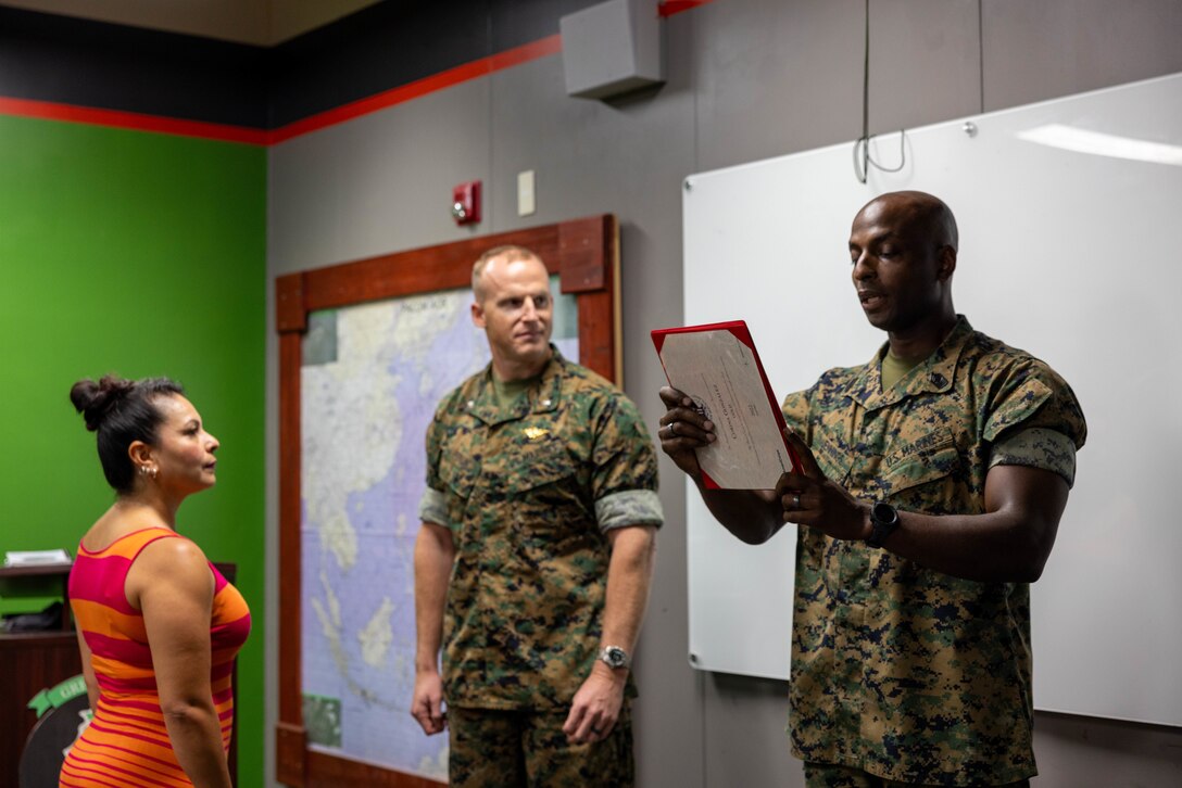 Corina Gonzalez, left, receives the gold Presidential Volunteer Service Award for over 500 hours of community service during an award presentation at Marine Corps Air Station Iwakuni, July 21, 2023. Since arriving to the installation in 2021, Gonzalez, a Marine Corps veteran and military spouse, worked with MCAS Iwakuni Marine Corps Family Team Building as a LINKS mentor, coordinated and facilitated events with the local USO, and wrote over $10,000 in checks for financial assistance in support of the Navy Marine Corps Relief Society in conjunction with supporting other volunteer organizations and causes throughout the installation. In 2003, the President’s Council on Service and Civic Participation was founded, and it continues to honor individuals whose service positively impacts communities in every corner of the globe today. (U.S. Marine Corps photo by Lance Cpl. Peter Rawlins)