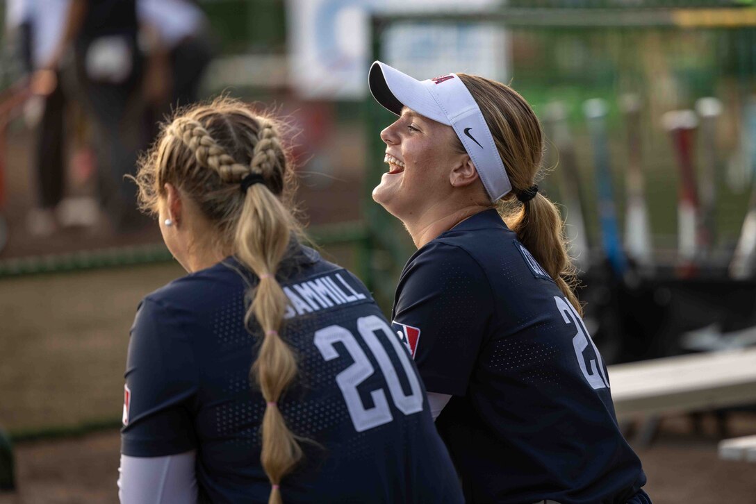 Hannah Gammil, left, and Erin Coffel, both members of the USA women’s national softball team, talk to each other before a USA – Japan international softball game at the Atago Sports Complex, Iwakuni, Japan, August 4, 2023. The USA women’s national softball team traveled to Japan to participate in a three-game all-star series with the Japan national team. (U.S. Marine Corps Photo by Cpl. Calah Thompson)