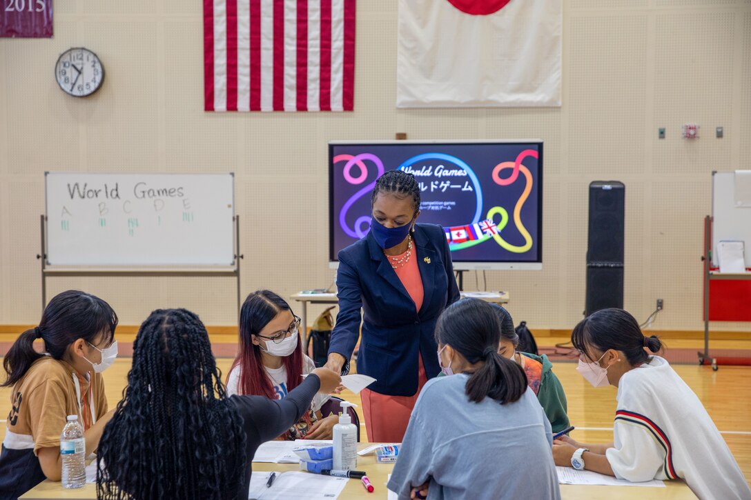 Latressa T. Cobb, principal of M.C. Perry High School, and students from M.C. Perry High School play a game during Global Friendship Camp at Marine Corps Air Station Iwakuni, Japan, Sept 18, 2022. The Global Friendship Camp is a school run event held to strengthen the bond between Japanese and American school children by learning more about each other's cultures. (U.S. Marine Corps photo by Lance Cpl. David Getz)