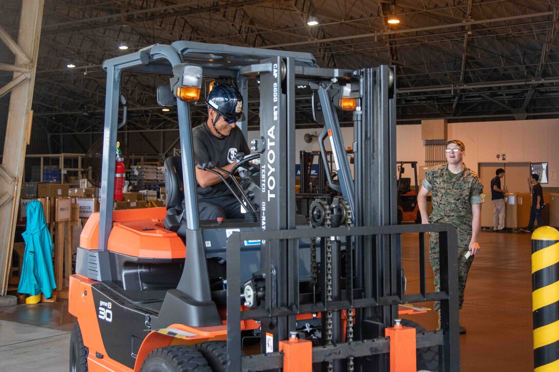 A Master Labor Contractor with the Distribution Management Office, Marine Corps Air Station Iwakuni, operates a forklift truck at MCAS Iwakuni, Japan, June 15, 2023. MLCs within the Distribution Management Office help break down the language barrier, make transportation arrangements, and communicate with local transportation services. (U.S. Marine Corps Photo by Cpl. Calah Thompson)
