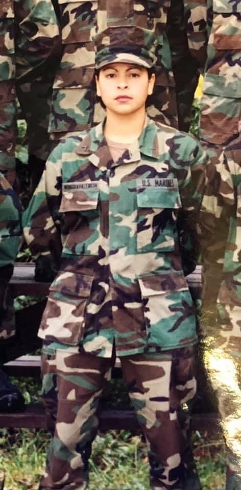 Then U.S. Marine Corps PFC Corina Gonzalez stands at parade rest for a group photo at Camp Johnson, North Carolina. Gonzalez is a Marine Corps veteran and loving mother who volunteers at numerous organizations throughout MCAS Iwakuni, and has proven to be a diligent and dedicated member of the community. (Courtesy photo by Corina Gonzalez)