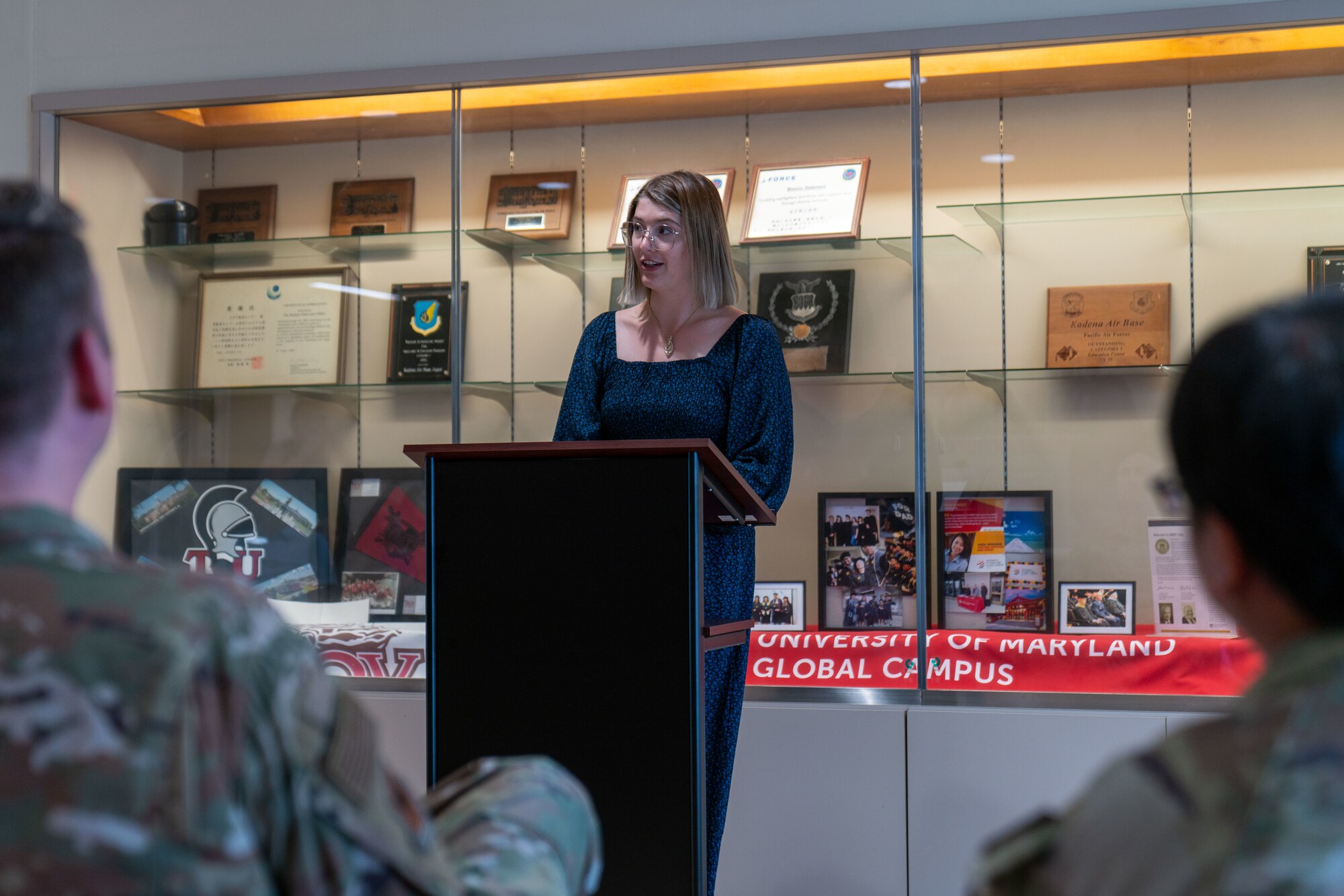 A spouse speaks during a ceremony.