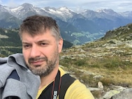 Enrico Munaron takes a selfie from atop the Alps. Munaron, who is an Italian local national employee with the U.S. Army, found out he was selected as the Logistics Readiness Center Italy Employee of the Quarter while on vacation hiking the Alps. (Courtesy photo)