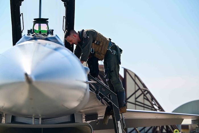 U.S. Air Force F-16 Fighting Falcon pilot helps Maj. Gen Thomas E. Kunkel, NATO Airborne Early Warning and Control Force commander, prepare for his flight in an F-16.