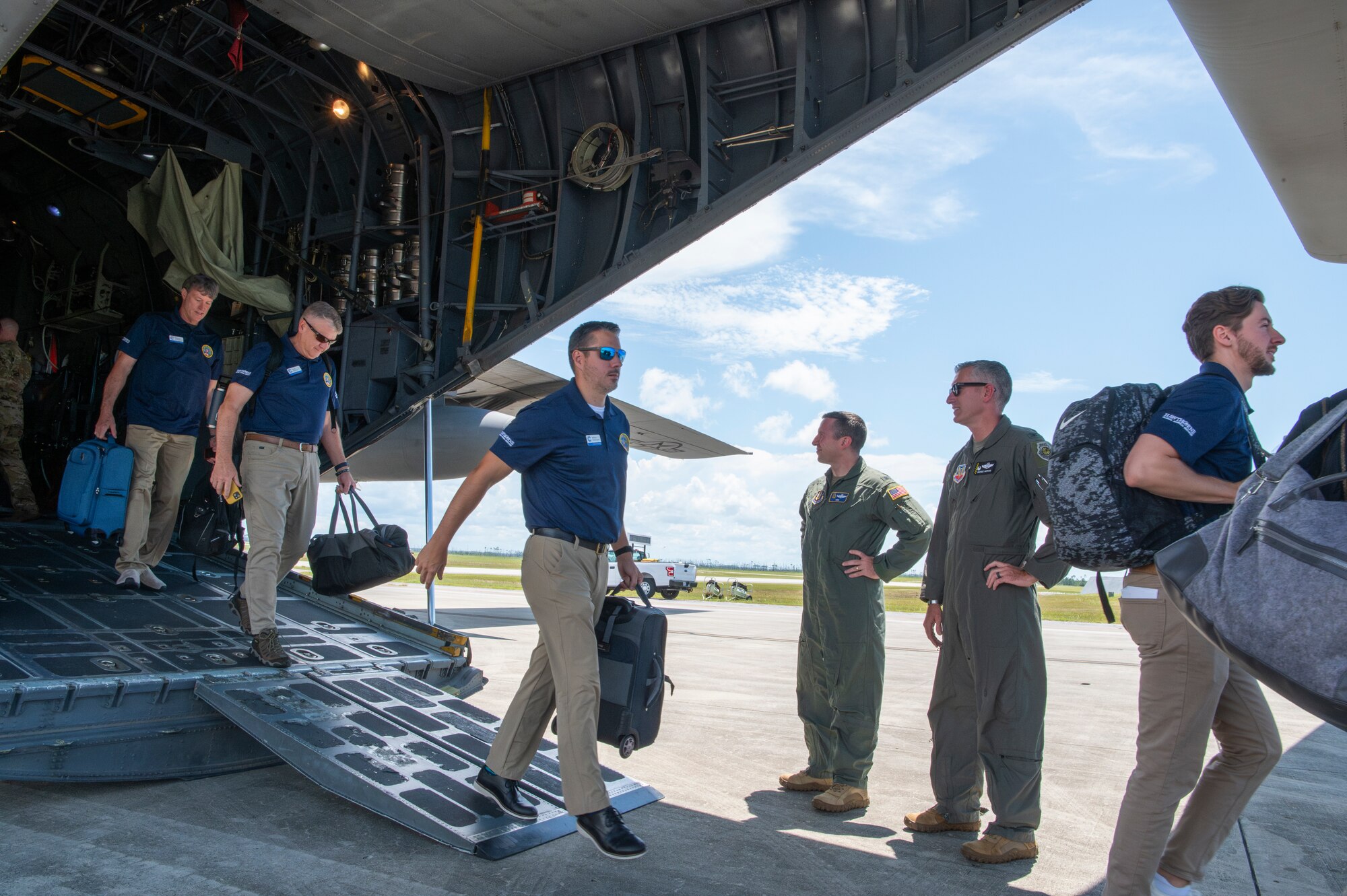 People step off the back of an aircraft
