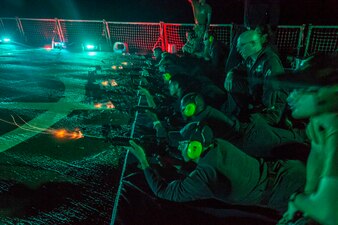 Sailors fire M4 carbines aboard USS Paul Hamilton (DDG 60) in the Pacific Ocean.
