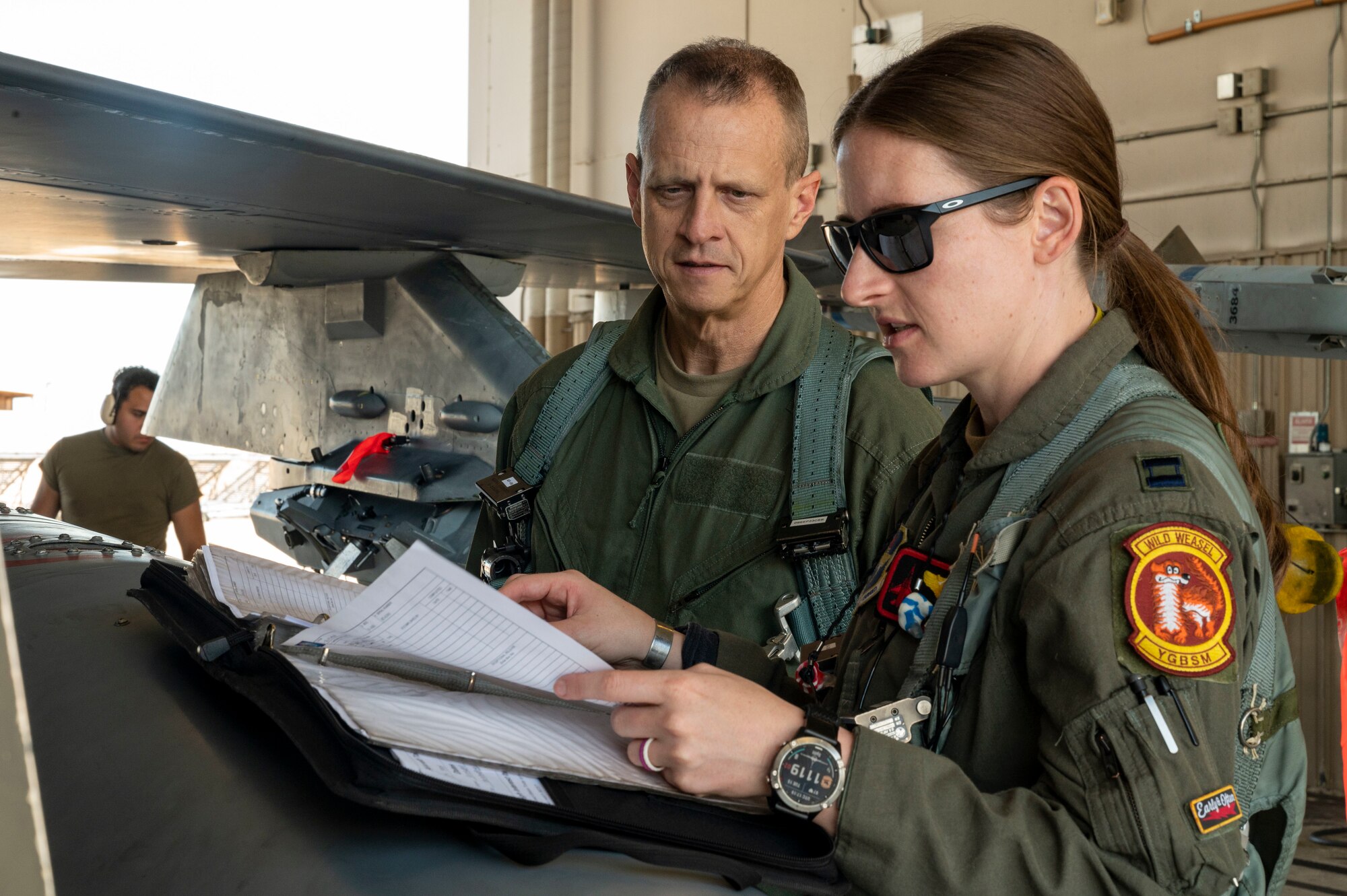 U.S. Air Force Capt. Ariel Demarzo, 8th Fighter Squadron flight commander, right, discusses the flight plan with U.S. Air Force Chief Master Sgt. Jeffrey Martin, 49th Wing command chief, at Holloman Air Force Base, New Mexico, Aug. 15, 2023.
