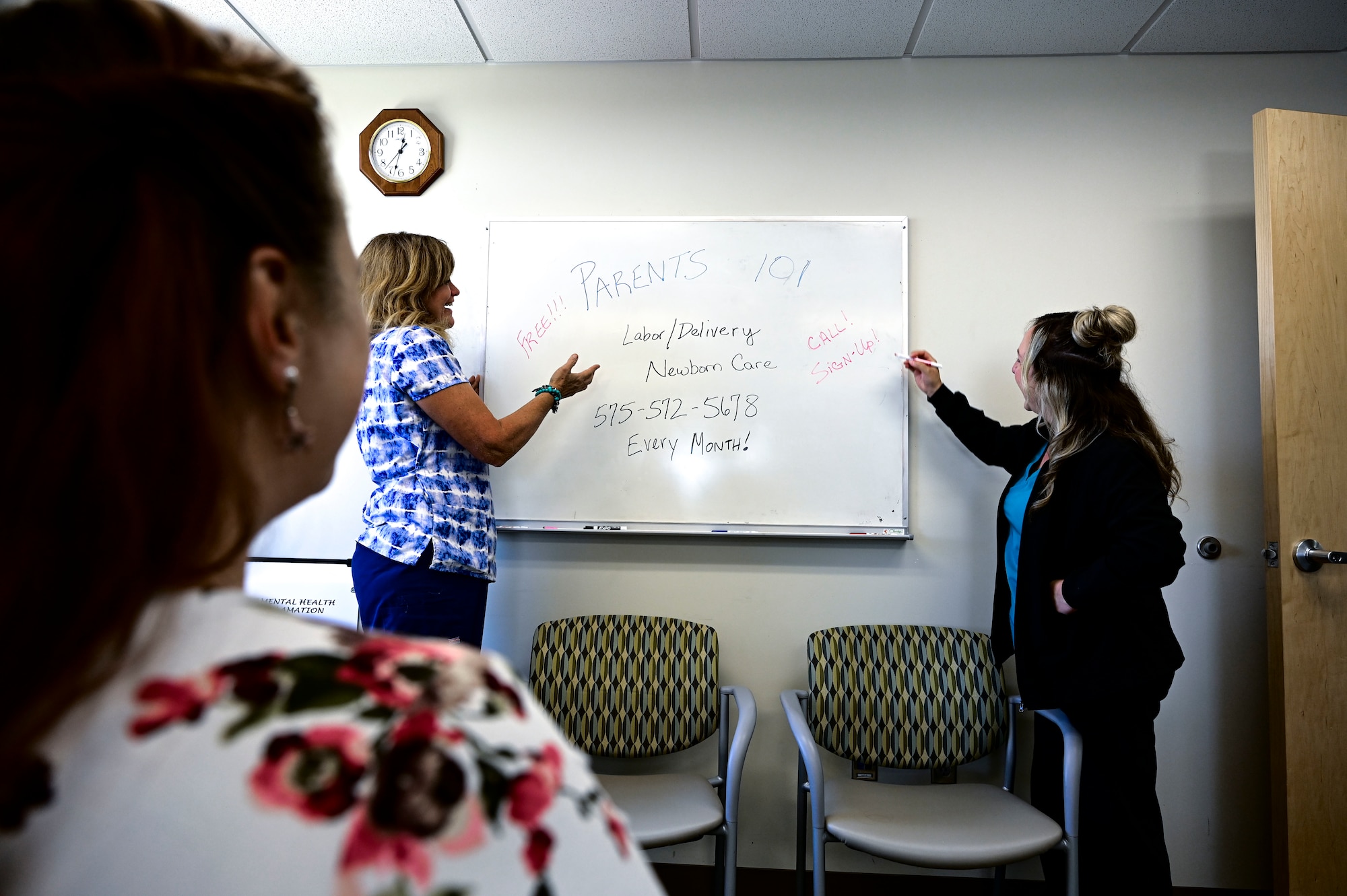 Candi Hutchins, 49th Medical Group parent support nurse, center and Cassandra Sanchez, 49th MDG family advocacy nurse, right, begin a mock Parents 101 class for Katie Novotney, 49th MDG mental health receptionist, at Holloman Air Force Base, New Mexico, Aug. 16, 2023. The Parents 101 class is a part of the New Parent Support Program designed to assist Airmen with newborn and young children and guide them in their path as new parents. (U.S. Air Force photo by Airman 1st Class Isaiah Pedrazzini)