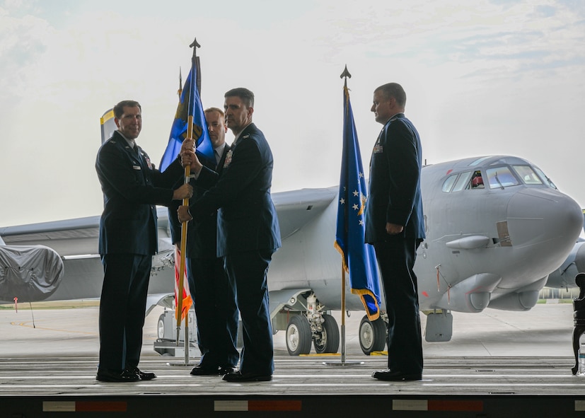 U.S. Air Force Col. Shaun Westphal, incoming 5th Medical Group (MDG) commander, receives the guidon from U.S. Air Force Col. Daniel Hoadley, 5th Bomb Wing commander, during the 5th MDG change of command ceremony at Minot Air Force Base, North Dakota, Aug. 18, 2023. The transfer of the guidon during the ceremony symbolizes the change of command. (U.S. Air Force photo by Airman 1st Class Kyle Wilson)