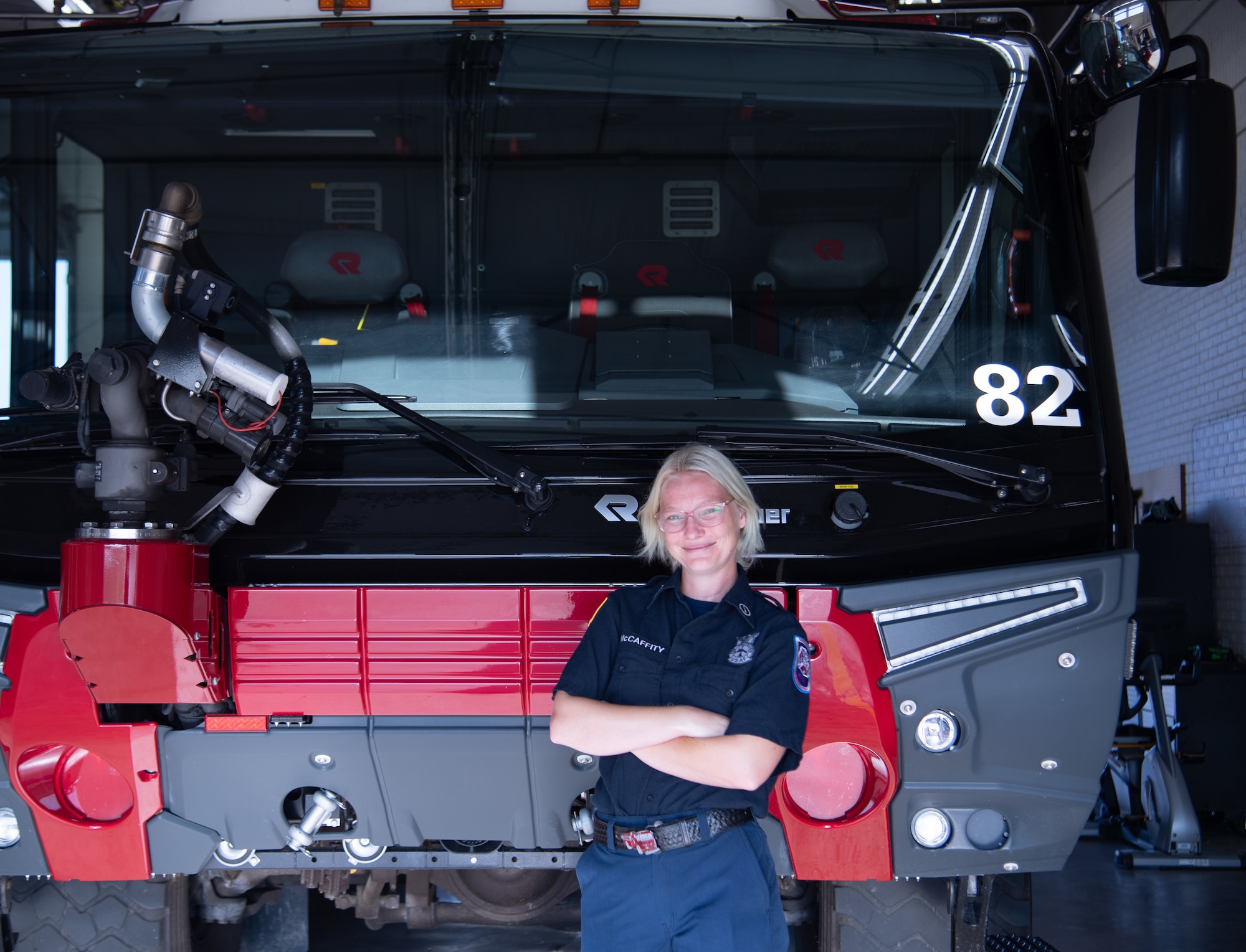 Samantha McCaffity, a Sheppard Air Force Base firefighter, stands in front of the Aircraft Rescue and Fire Fighting truck Aug. 10, 2023, here. McCaffity received the Senior Master Sgt. Robert A. McAllister Heroism award for her life-saving actions during a dorm fire.