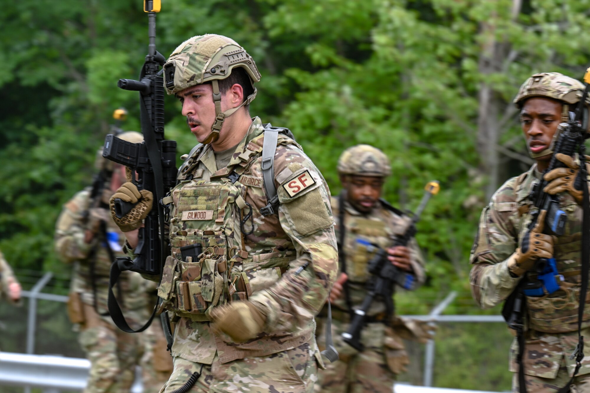 Airman 1st Class Trent Gilwood, a Defender assigned to the 349th Security Forces Squadron, Travis Air Force Base, California, runs with fellow Defenders during a tactical combat casualty care exercise on Aug. 16, 2023, at Youngstown Air Reserve Station, Ohio.