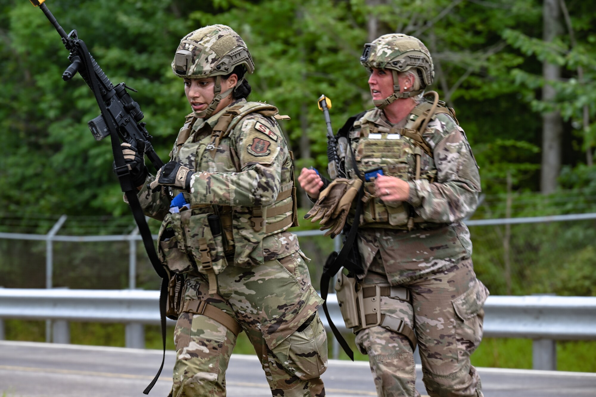 Airman 1st Class Karla Renteria, a Defender assigned to the 349th Security Forces Squadron, Travis Air Force Base, California, and Staff Sgt. Arin Brown, a Defender assigned to the 919th SFS, Duke Field, Florida, run during a tactical combat casualty care exercise on Aug. 16, 2023, at Youngstown Air Reserve Station, Ohio.