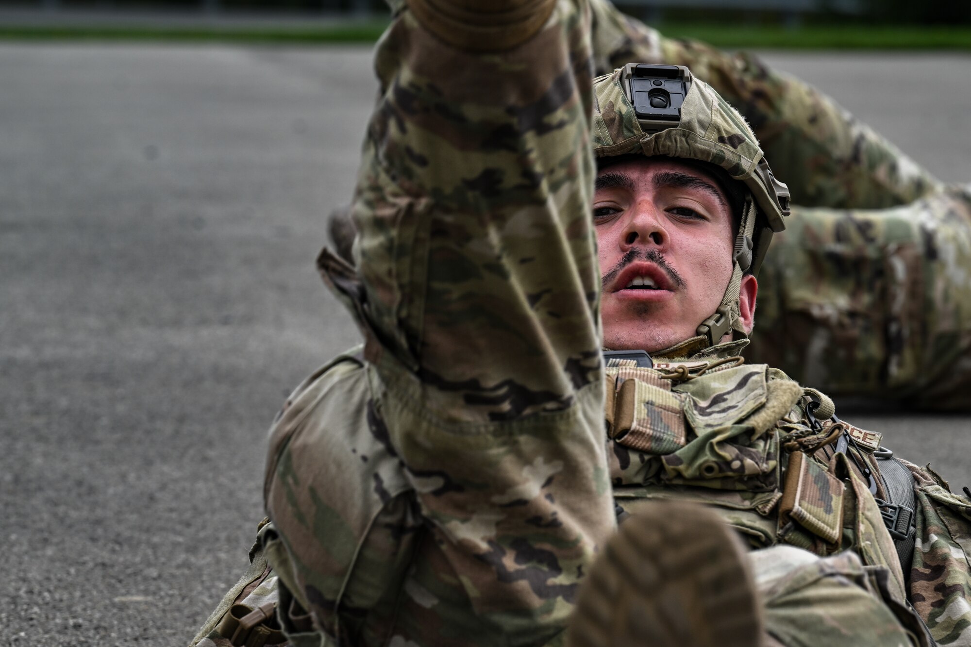 Airman 1st Class Trent Gilwood, a Defender assigned to the 349th Security Forces Squadron, Travis Air Force Base, California, executes flutter kicks during a tactical combat casualty care exercise on Aug. 16, 2023, at Youngstown Air Reserve Station, Ohio.