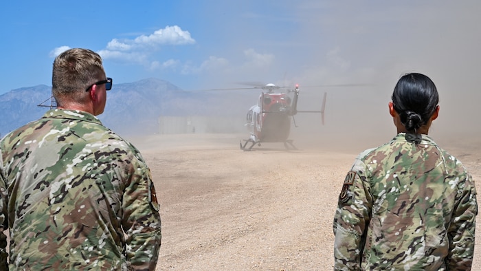 Technicians from the 775th Explosive Ordnance Disposal Flight watch as the University of Utah AirMed helicopter lands at 775th EOD's proficiency range Aug. 17, 2023, at Hill Air Force Base,