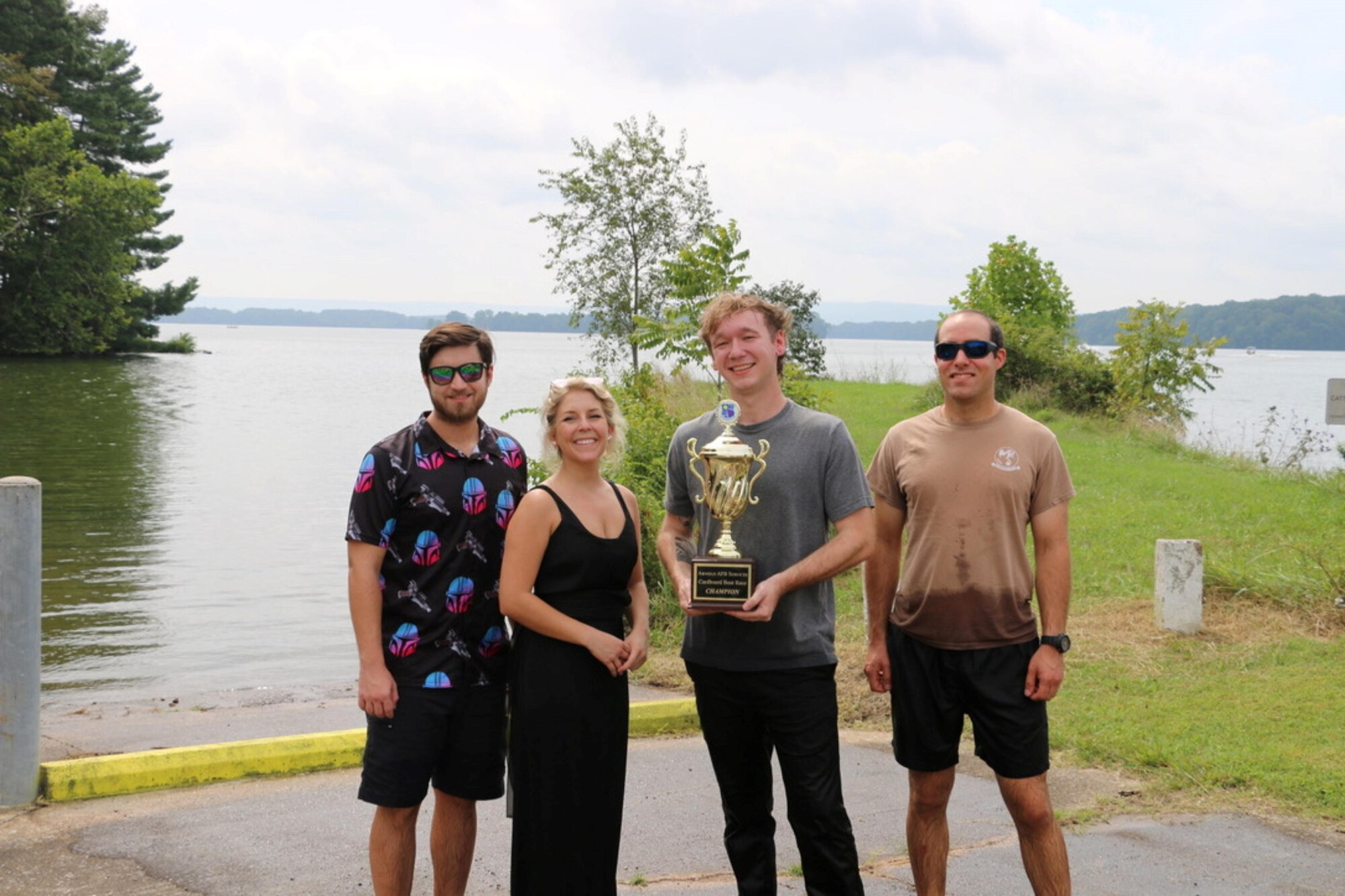 The NAS Design Team, winners of the cardboard boat race, display the trophy earned for their top finish during the first-ever Arnold Air Force Base Services SummerFest Aug. 12, 2023, at the Gossick Leadership Center on Arnold Air Force Base, Tenn. Along with the cardboard boat race, the event featured pie eating contests, a car show, a dunking booth, bounce houses and food trucks, among other activities. (U.S. Air Force photo by Jodee George)