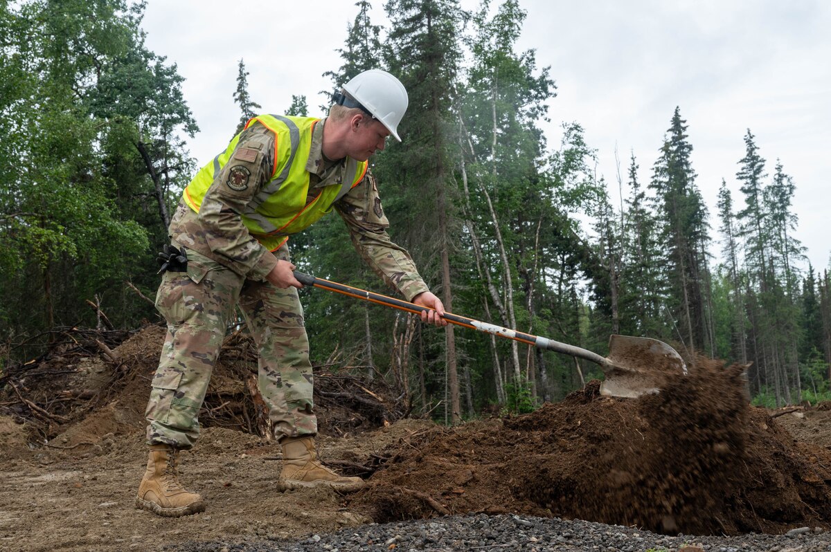 Senior Airman Nathan Smith, a 934th Airlift Wing Civil Engineering Squadron engineering journeyman, fills a back trench while upgrading Camp Mad Bull’s electrical system at Joint Base Elmendorf-Richardson, Alaska, on Aug. 9, 2023. The 934 AW CES was at the site for over two months in a series of 3 different rotations to effectively complete the mission. (Air Force photo by Senior Airman Matthew Reisdorf)