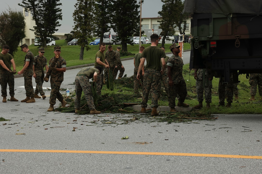 U.S. Marines with 3rd Marine Division and III Marine Expeditionary Force loads debris onto a USMC 7-ton truck on Camp Courtney, Okinawa, Aug. 7, 2023. Typhoon Khanun moved through Okinawa as a category 4 hurricane equivalent storm, bringing strong winds, heavy rain, and high waves, marking one of the strongest storms to affect the island in recent years. Immediately after the storm, crews from across Marine Corps Installation Pacific and III MEF began assessing damage and initiating repair work to ensure the Marines on Okinawa remain operationally ready.