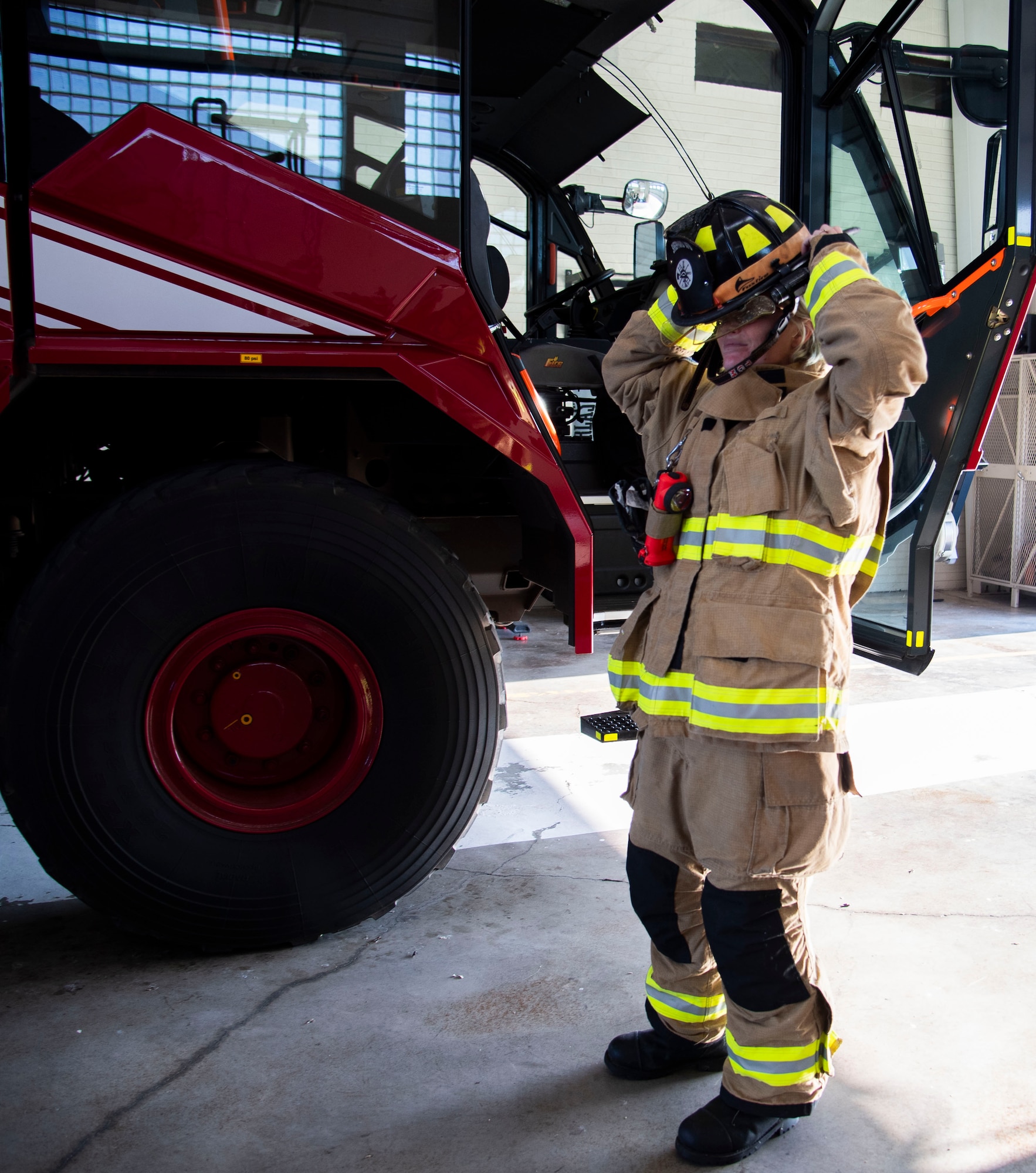 Samantha McCaffity, a Sheppard Air Force Base firefighter, gears up Aug. 10, 2023, here. McCaffity received the Senior Master Sgt. Robert A. McAllister Heroism award for her life-saving actions during a dorm fire.
