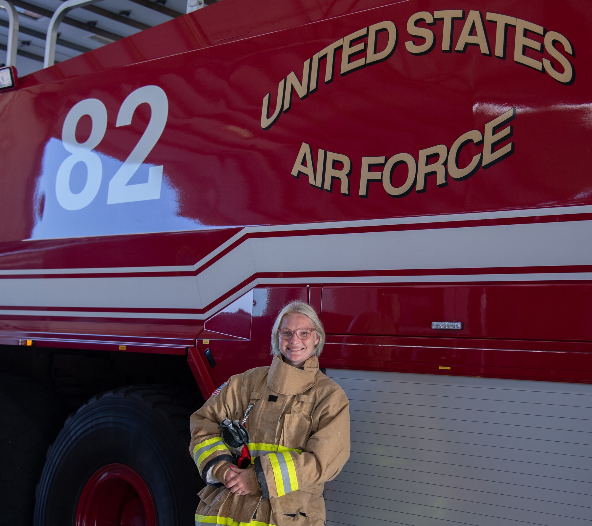 Samantha McCaffity, a Sheppard Air Force Base firefighter, stands beside the Aircraft Rescue and Fire Fighting truck Aug. 10, 2023, here. McCaffity received the Senior Master Sgt. Robert A. McAllister Heroism award for her life-saving actions during a dorm fire.