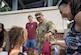 Children from military families collect donated school supplies from various tables at the Fort Eustis Block Party at Joint Base Langley-Eustis, Virginia, August 17, 2023.