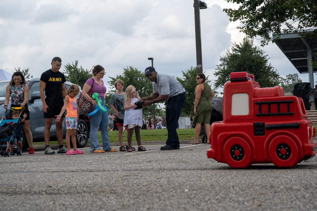Jason Percy, Fort Eustis firefighter demonstrates how to operate ‘Freddie the Firetruck’ to children during the Fort Eustis Block Party at Joint Base Langley-Eustis, Virginia, Aug. 17, 2023.