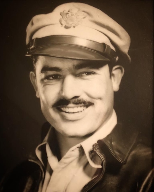 An airman in Korean War-era clothing poses for a photo.