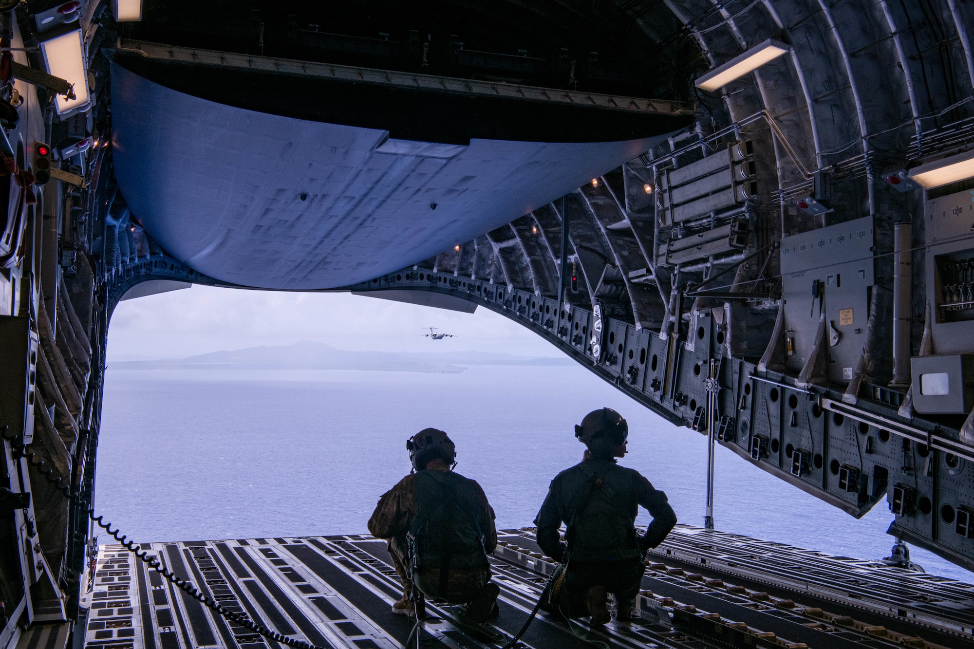 Coalition loadmasters look out over the Pacific Ocean from an Australian C-17 during a Joint airdrop
near Andersen Air Force Base, Guam on July 12, 2023. This airdrop was part of Mobility Guardian 23
and showed how Allies and partners are capable of resupplying remote areas. MG23 is a mobility
exercise held across a 3,000-mile area intended to deepen interoperability with U.S. Allies and
partners, bolstering the collective ability to support a free and open Indo-Pacific area. (U.S. Air Force
photo by A1C Caleb Parker)