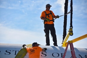 Contract workers prepare a static U.S. Air Force Lockheed JetStar C-140B display aircraft to be relocated next to the 89th Airlift Wing headquarters building at Joint Base Andrews, Maryland, August 17, 2023. The C-140B aircraft were used for Military Airlift Command personnel transports, and also for 89 AW executive airlift operations where the planes were adorned with the distinctive blue and white with gold trim paint design associated with the Special Air Mission assignment and given the designation of VC-140B. (U.S. Air Force photo by Staff Sgt. Gabrielle Winn)