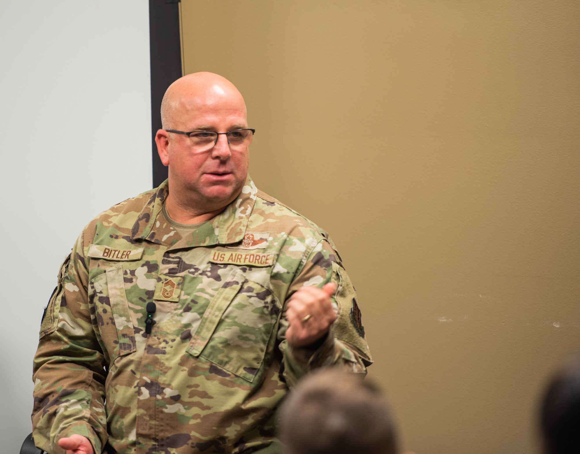 A chief speaks to a classroom full of Airmen about the responsibilities of the senior enlisted tier