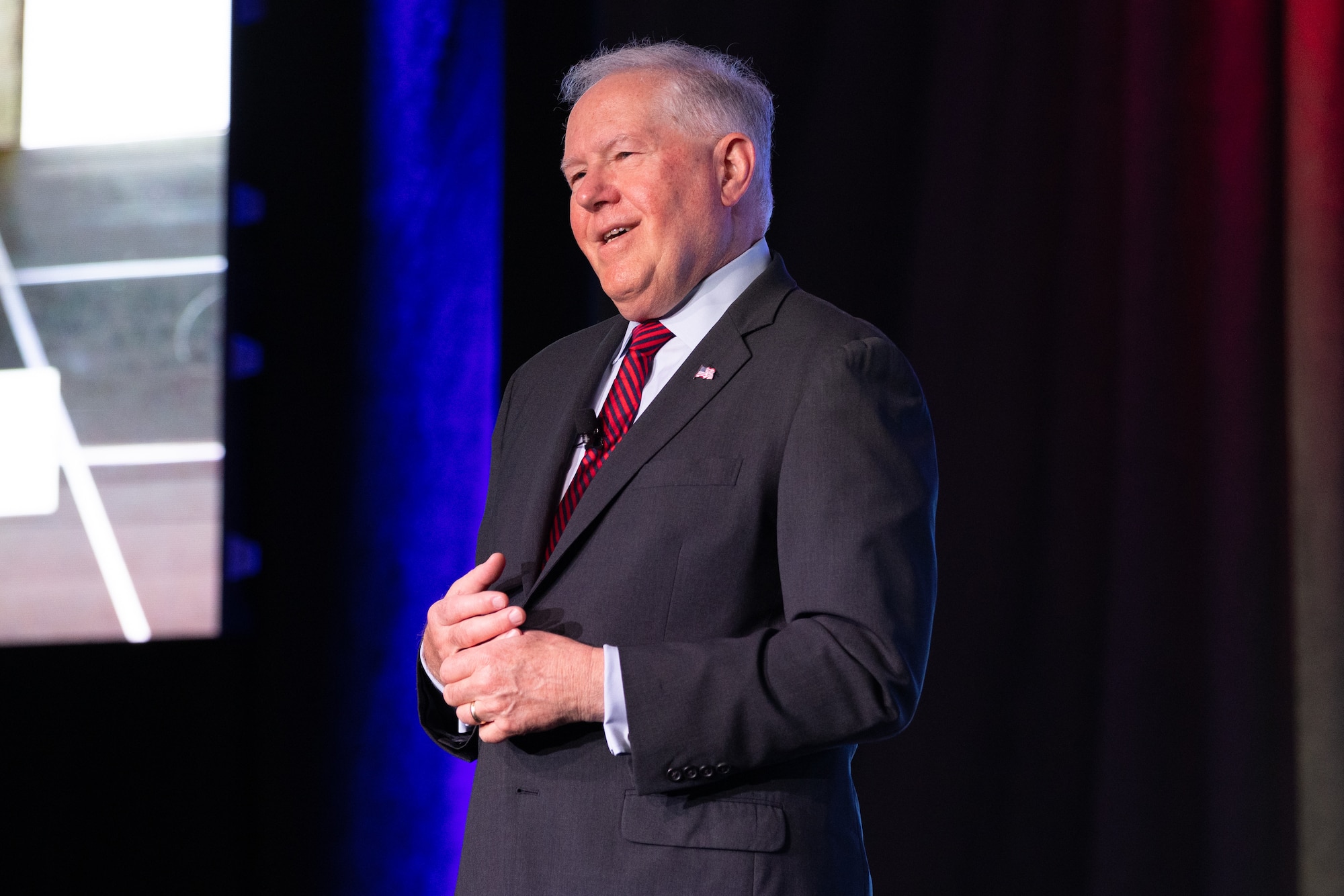 Man in suit speaking on stage