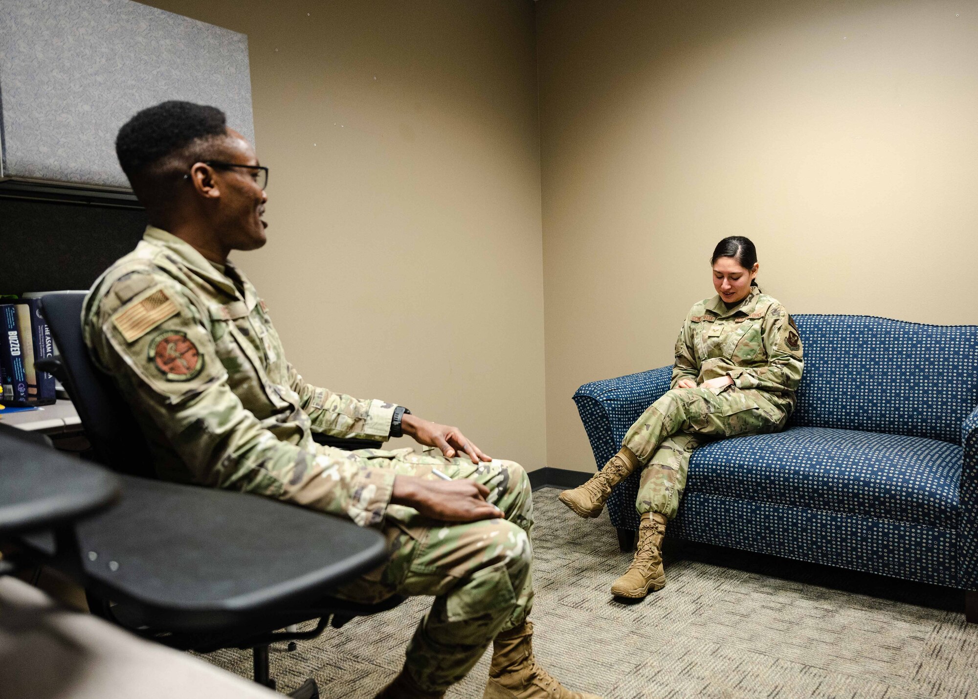 Senior Airman Kiige, 2nd Medical Group mental health technician, speaks to Senior Airman Emma Gomez-Felix, 2nd Medical Group ADAPT technician.
