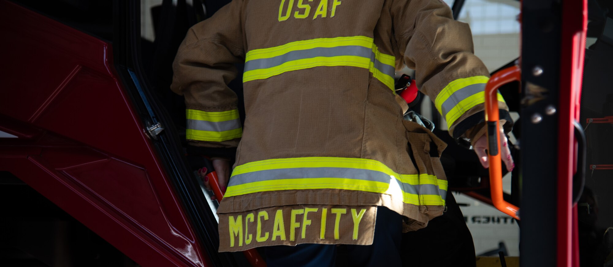 Samantha McCaffity, a Sheppard Air Force Base firefighter, climbs into the Aircraft Rescue and Fire Fighting truck Aug. 10, 2023, here. McCaffity received the Senior Master Sgt. Robert A. McAllister Heroism award for her life-saving actions during a dorm fire.