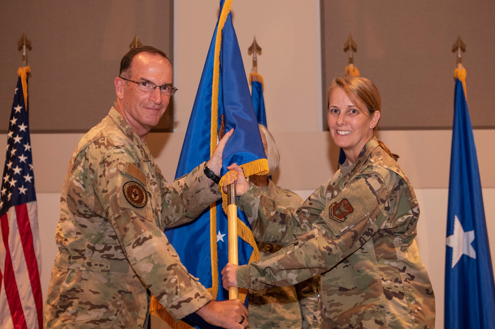 Brig. Gen. Jennie Johnson, former Headquarters Air Reserve Personnel Center commander, relinquishes the flag to Lt. Gen. John Healy, Chief of Air Force Reserve, Commander, Air Force Reserve Command during a Change of Command ceremony on Buckley Space Force Base, Colorado, 21 August 2023.