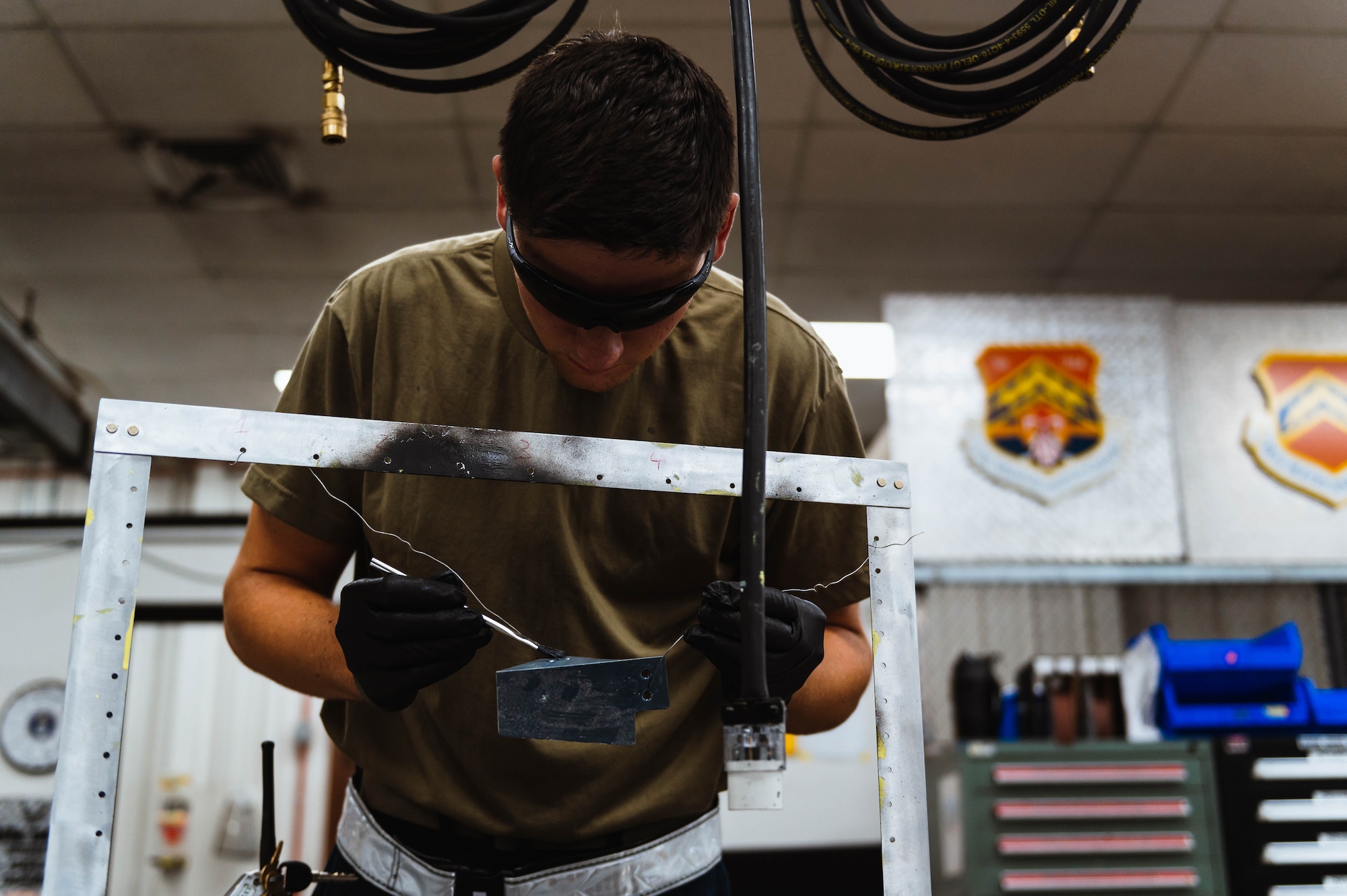 U.S. Air Force Senior Airman Caden Koranda, 56th Equipment Maintenance Squadron structural maintenance technician, paints a canopy closeout fairing.