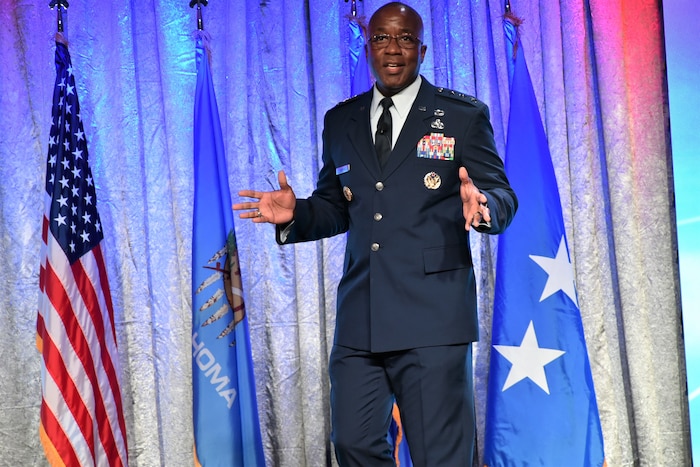 Man in Air Force uniform speaking on stage