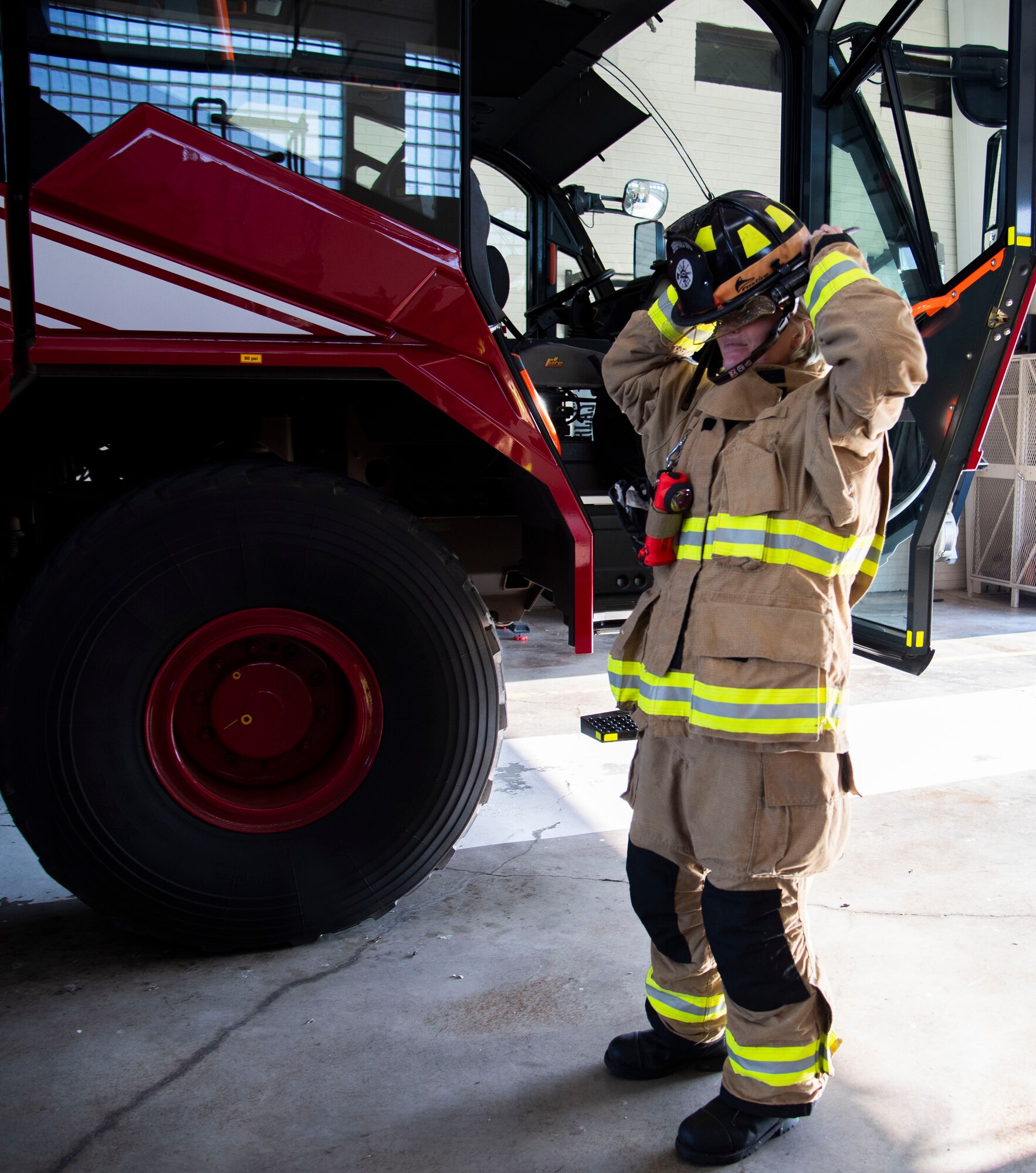 Samantha McCaffity, a Sheppard Air Force Base firefighter, gears up Aug. 10, 2023, here. McCaffity received the Senior Master Sgt. Robert A. McAllister Heroism award for her life-saving actions during a dorm fire.