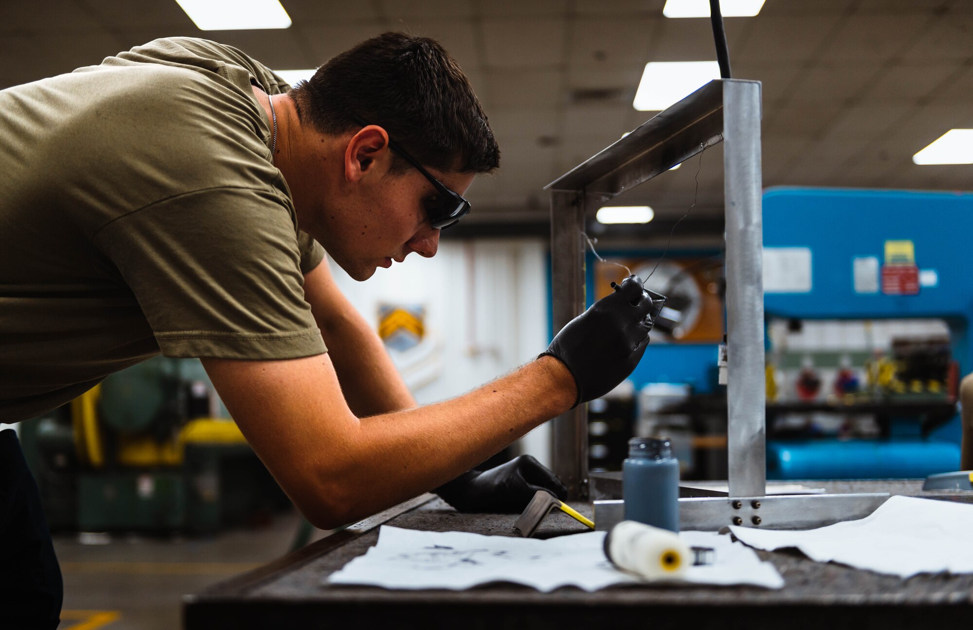U.S. Air Force Senior Airman Caden Koranda, 56th Equipment Maintenance Squadron aircraft structural maintenance technician, paints a canopy closeout fairing.