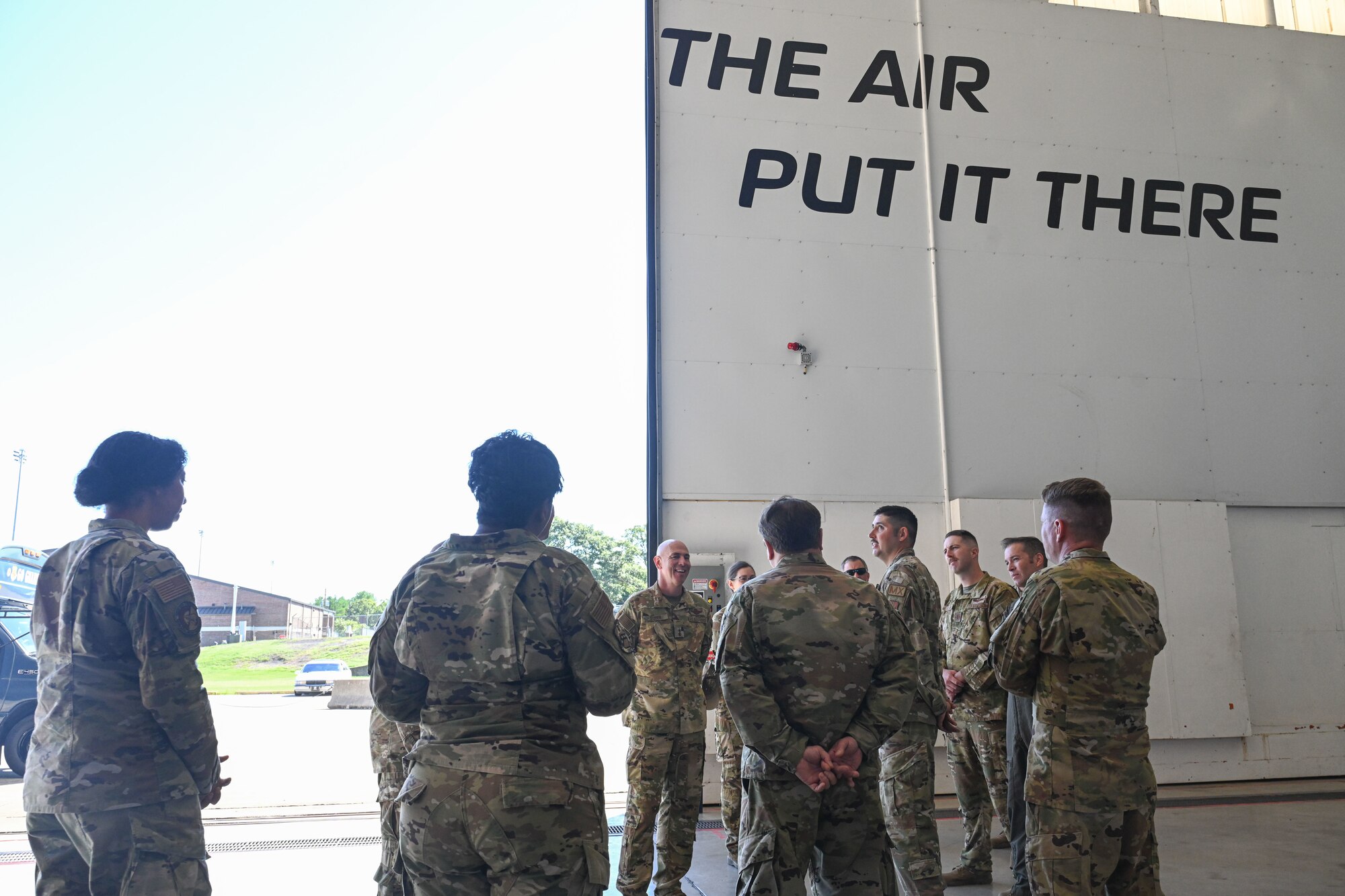 man in uniform gets briefed by personnel