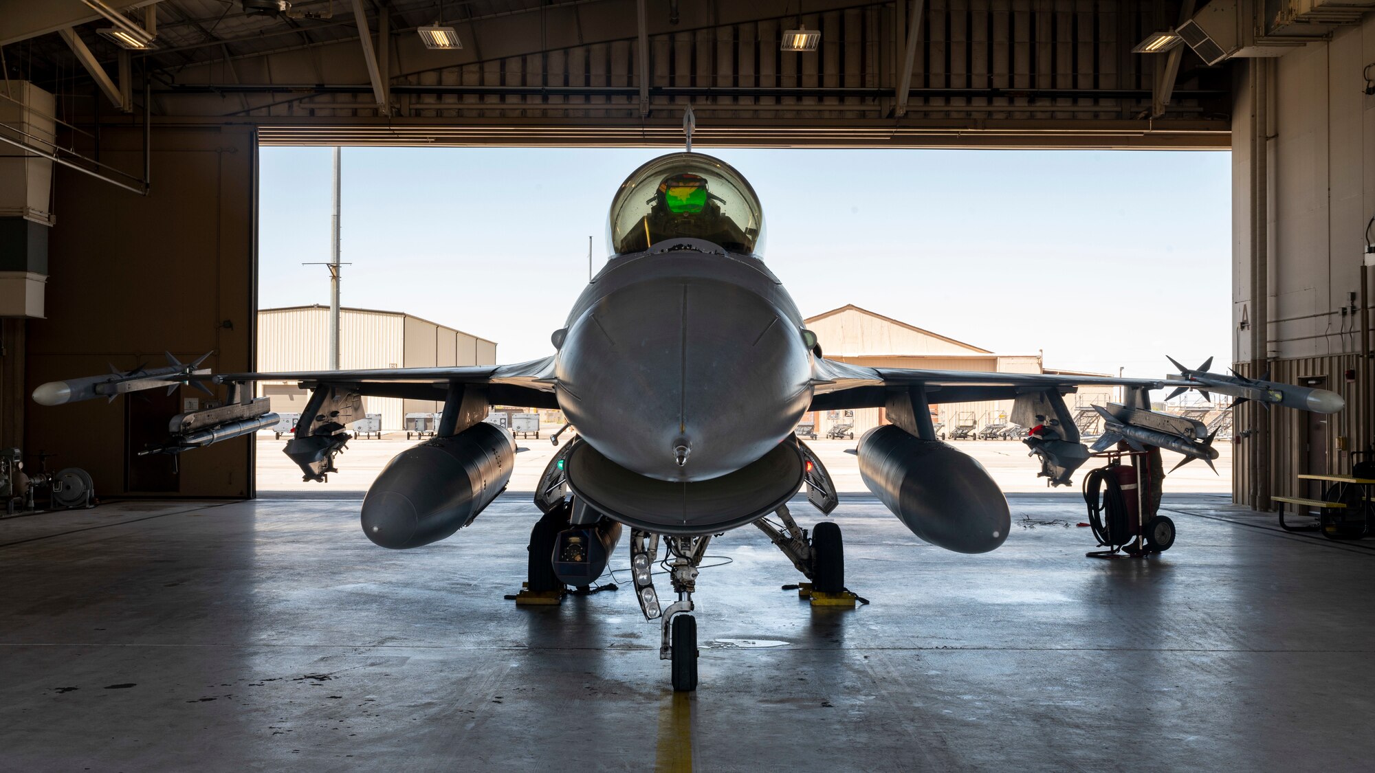 U.S. Air Force Capt. Ariel Demarzo, 8th Fighter Squadron flight commander, prepares to exit a hangar at Holloman Air Force Base, New Mexico, Aug. 15, 2023.